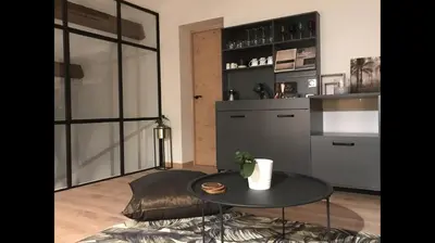 a living room with a table and a kitchen at Chambres d'hôtes La Manola in Rognes
