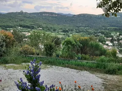 a view from a garden with flowers in the foreground at T.Belle Vue Panoramique au coeur du Luberon 40m2 + pergola . jardin. P in Apt