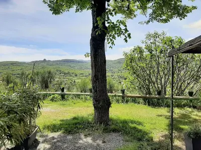 a tree in the middle of a field with a fence at T.Belle Vue Panoramique au coeur du Luberon 40m2 + pergola . jardin. P in Apt