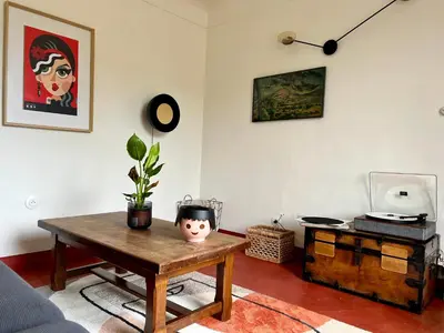 a living room with a table and a tv at Le Cabanon de Léandre in Meyrargues