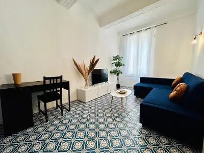 a bedroom with a large bed with white sheets and pillows at L'Aixalté - T2, Vieille Ville in Aix-en-Provence