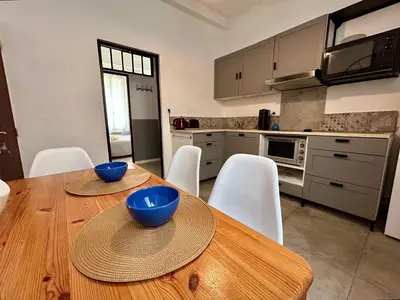 a kitchen with a wooden table with bowls on it at L'Aixalté - T2, Vieille Ville in Aix-en-Provence