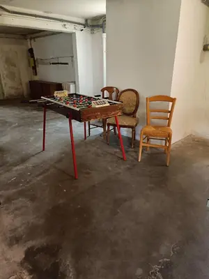 a ping pong table and two chairs in a room at A l'ombre de l'olivier in Orgon