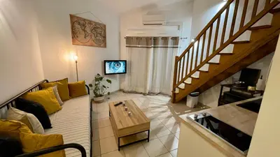 a living room with a couch and a table at ADDIS 2 in Salon-de-Provence