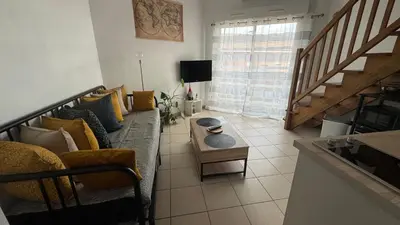 a living room with a couch and a table at ADDIS 2 in Salon-de-Provence