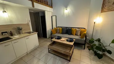 a living room with a couch and a table at ADDIS 2 in Salon-de-Provence