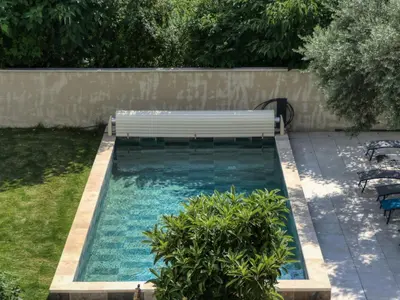a swimming pool with a bench in a backyard at Coeur de Provences in Saint-Didier