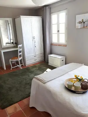 a bedroom with a bed with a plate of fruit on it at La bastide de Cocagne in Rognes