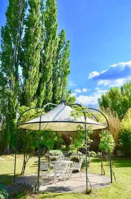 a gazebo with two chairs and a table at maison bertuli Oliviers Aircon, heated saltwater Pool, 2 Bedrooms in Oppède