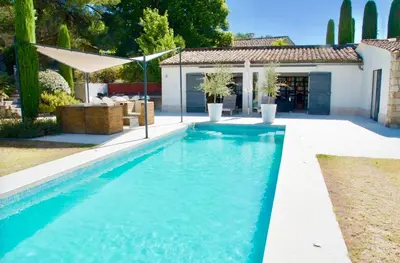 a swimming pool in the backyard of a house at maison bertuli Oliviers Aircon, heated saltwater Pool, 2 Bedrooms in Oppède