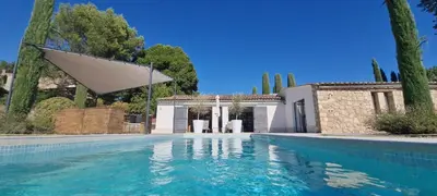 a swimming pool in front of a house at maison bertuli Oliviers Aircon, heated saltwater Pool, 2 Bedrooms in Oppède