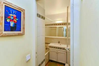 a bathroom with a sink and a painting on the wall at Village Pont Royal en Provence - maeva Home - Appartement 2 pièces 5 personnes Sélection MAE-2264 in Mallemort