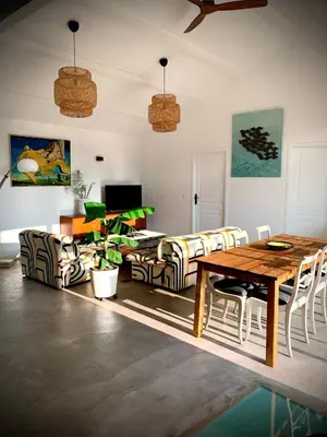 a living room with a wooden table and chairs at Viva la vida in Entraigues-sur-la-Sorgue