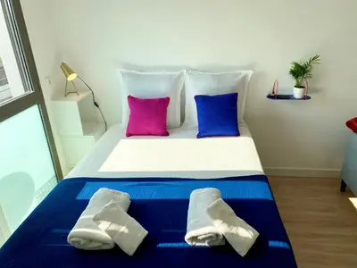 a bed with two pillows and towels on it at Ma place au sud 1.08 in Éguilles