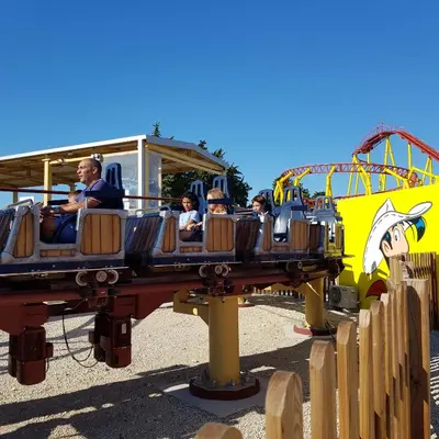 a group of people riding on a roller coaster at vacances en provence cyprès in Mormoiron
