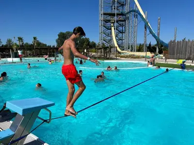 a young man jumping in a swimming pool at vacances en provence cyprès in Mormoiron