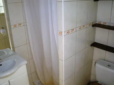 a bathroom with a shower curtain and a sink at vacances en provence cyprès in Mormoiron