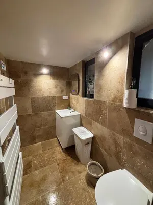 a bathroom with a toilet and a sink at Le Pavillon de Nina in Puget