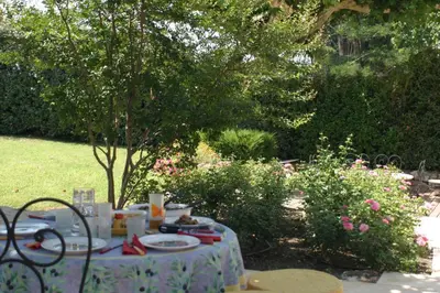 a table with food on it in a garden at Mirabelle en Provence in Eygalières