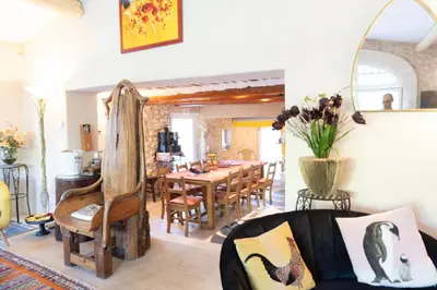 a living room with a table and a dining room at Mirabelle en Provence in Eygalières