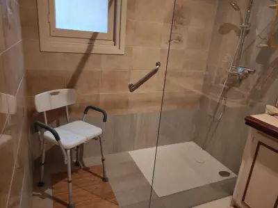 a shower with a white chair in a bathroom at Roussillon in Roussillon