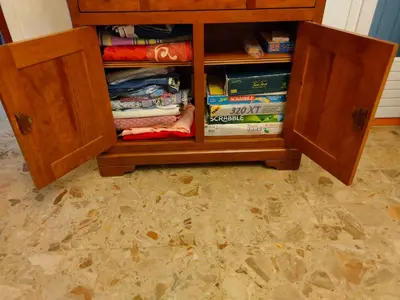 a cabinet filled with books on top of a floor at Roussillon in Roussillon
