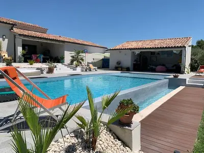 a swimming pool in front of a house at Charmant Appartement au calme avec piscine au pied du Ventoux en Provence in Carpentras