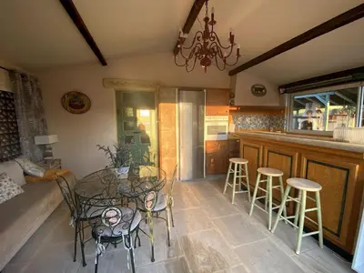 a dining room with a glass table and stools at Mas de Peyre in Le Beaucet