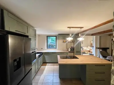 a kitchen with a sink and a refrigerator at Mas de Peyre in Le Beaucet