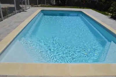 a large swimming pool with blue water in it at Le Cavaou in Mérindol