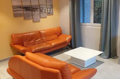 a living room with a couch and a table at Le Cavaou in Mérindol