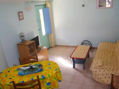 a room with a bed and a table and a chair at vacances en provence olivier in Mormoiron