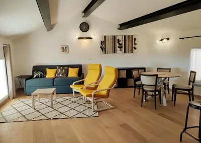 a living room with a couch and chairs and a table at BOHO 2 Vue Panoramique in Bonnieux
