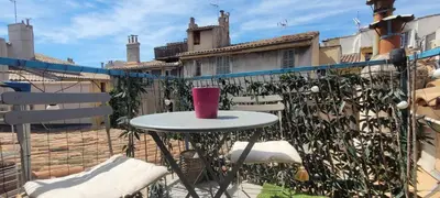a pink cup sitting on a table on a patio at Appartement duplex sur les toits d'Aix avec terrasse ensoleillée in Aix-en-Provence