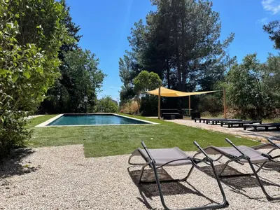 a group of chairs and a swimming pool at Superbe annAix de villa - Maison Odonata in Aix-en-Provence
