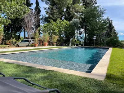 a swimming pool in the middle of a yard at Superbe annAix de villa - Maison Odonata in Aix-en-Provence