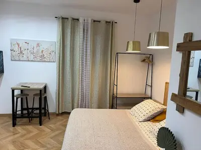 a bedroom with a bed and a table and a desk at 4M Studio in Jouques