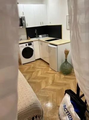 a kitchen with white cabinets and a white stove top oven at 4M Studio in Jouques