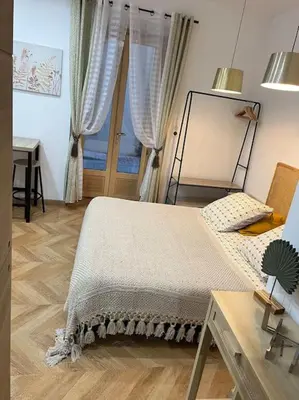 a bedroom with a bed and a desk and a window at 4M Studio in Jouques