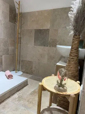 a bathroom with a table with a vase on it at 4M Studio in Jouques