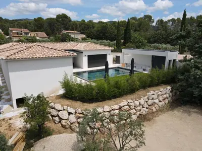 a house with a swimming pool and a stone wall at Villa de luxe en Provence Piscine Chauffée in Puget