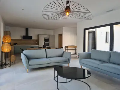 a living room with two blue couches and a table at Villa de luxe en Provence Piscine Chauffée in Puget