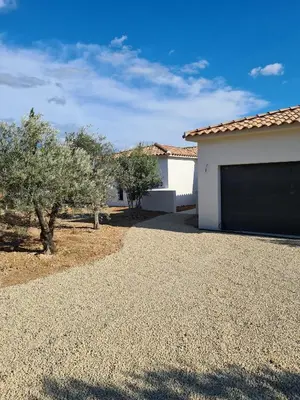 a house with a garage and trees in front of it at Villa de luxe en Provence Piscine Chauffée in Puget