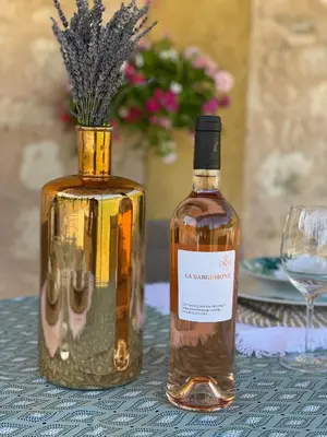a bottle of whisky sitting on a table with a glass at Maison Campagne Aixoise in Éguilles