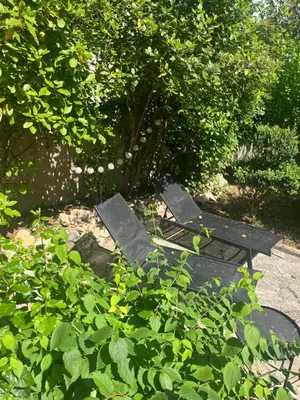 a picnic table and bench in a garden at Le Verger in Aix-en-Provence