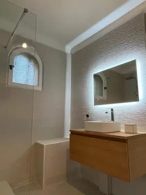 a bathroom with a sink and a mirror and a shower at Le Verger in Aix-en-Provence
