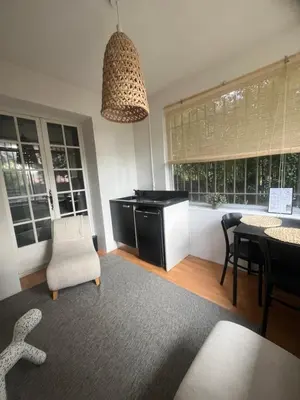 a living room with a desk and a table and chairs at Le Verger in Aix-en-Provence