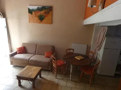 a living room with a couch and a table at Mas Seraphin in LʼIsle-sur-la-Sorgue