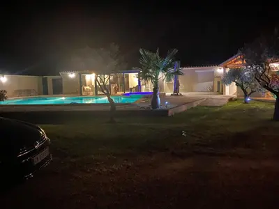 a house with a swimming pool at night at Petit paradis en Provence in Velleron