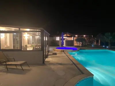 a house with a swimming pool at night at Petit paradis en Provence in Velleron